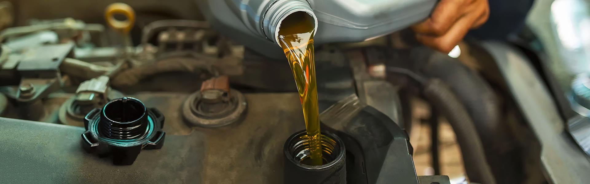 Engine oil being poured during an oil change service.
